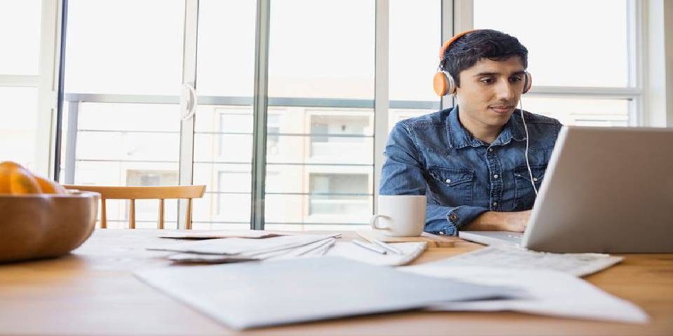 Image That Depics A Teenage Boy Hearing Music While Studying For His IAS Coaching Exams.