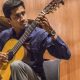 An Indian Musician Changing The Chords While Playing Guitar.