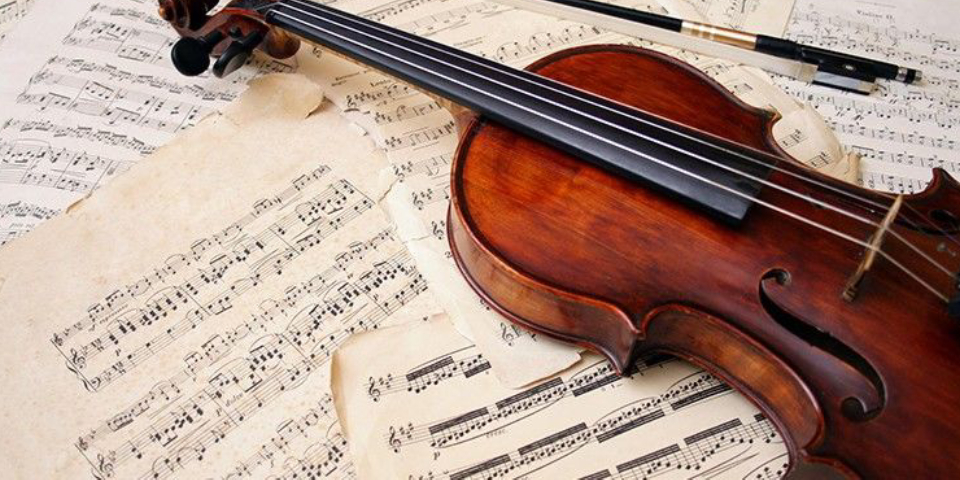 Collection of Musical Notes & papers Placed On The Table With Violin.