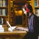 A person Studying With His Laptop While Hearing Music.