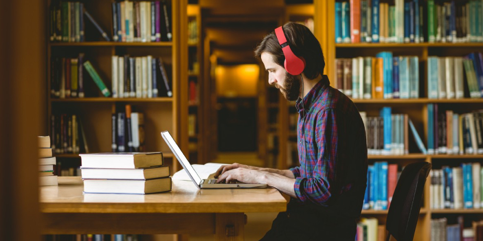 A person Studying With His Laptop While Hearing Music.