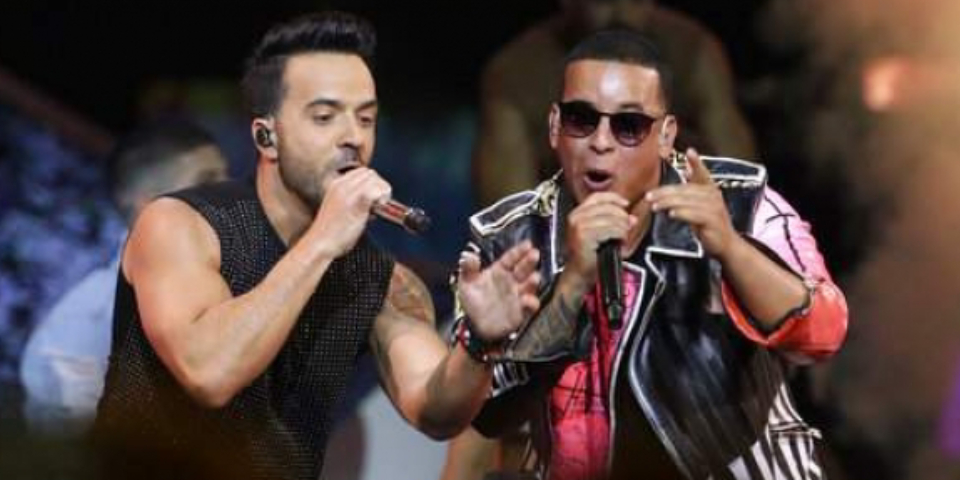 Two Lead Male Pop Musicians Performing In A Concert.