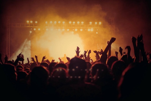 An image representing a music artist manager managing a music concert.