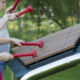 A young boy and girl playing a huge xylophone in their garden.