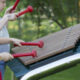 A young boy and girl playing a huge xylophone in their garden.